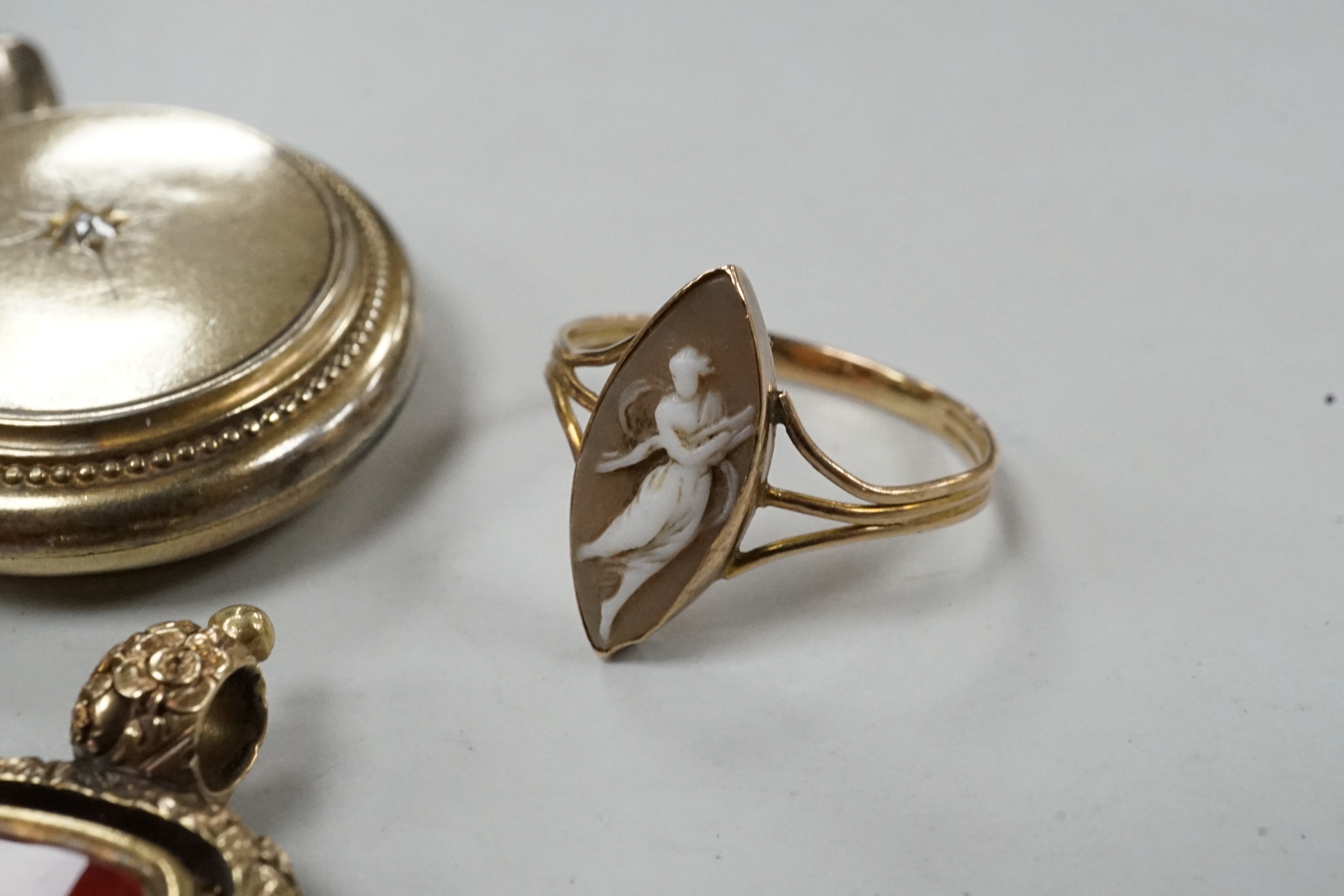 Assorted Victorian jewellery including cameo shell brooch and ring, diamond set locket, brooch, spinning fob seal and three unmounted carnelian intaglios.